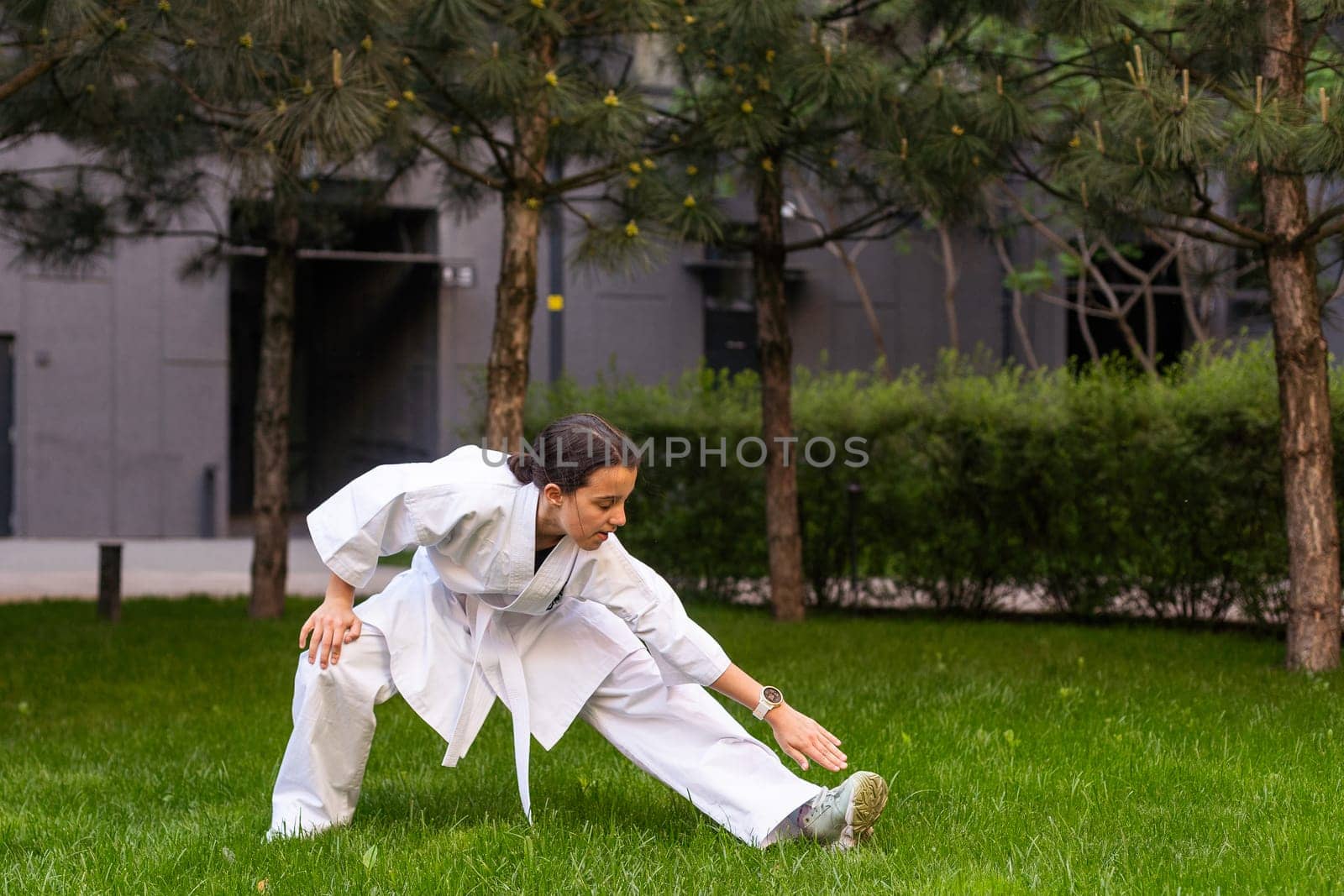 young girl in a white kimono, karate. High quality photo