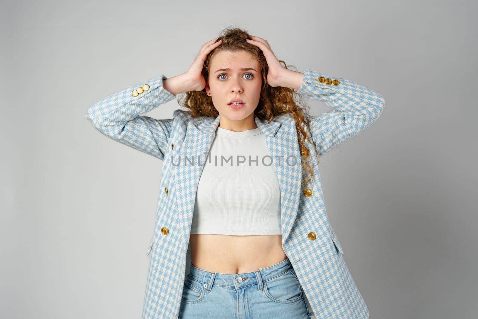 Young Businesswoman Gesturing Excitement or Surprise Against a Neutral Background close up