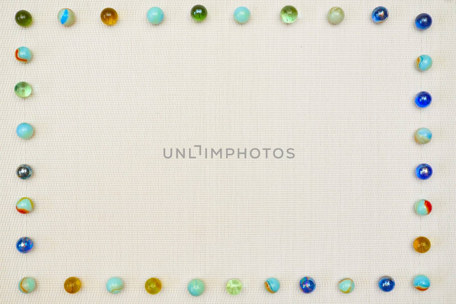 Linen gray fabric framed by colorful glass balls for text by jovani68