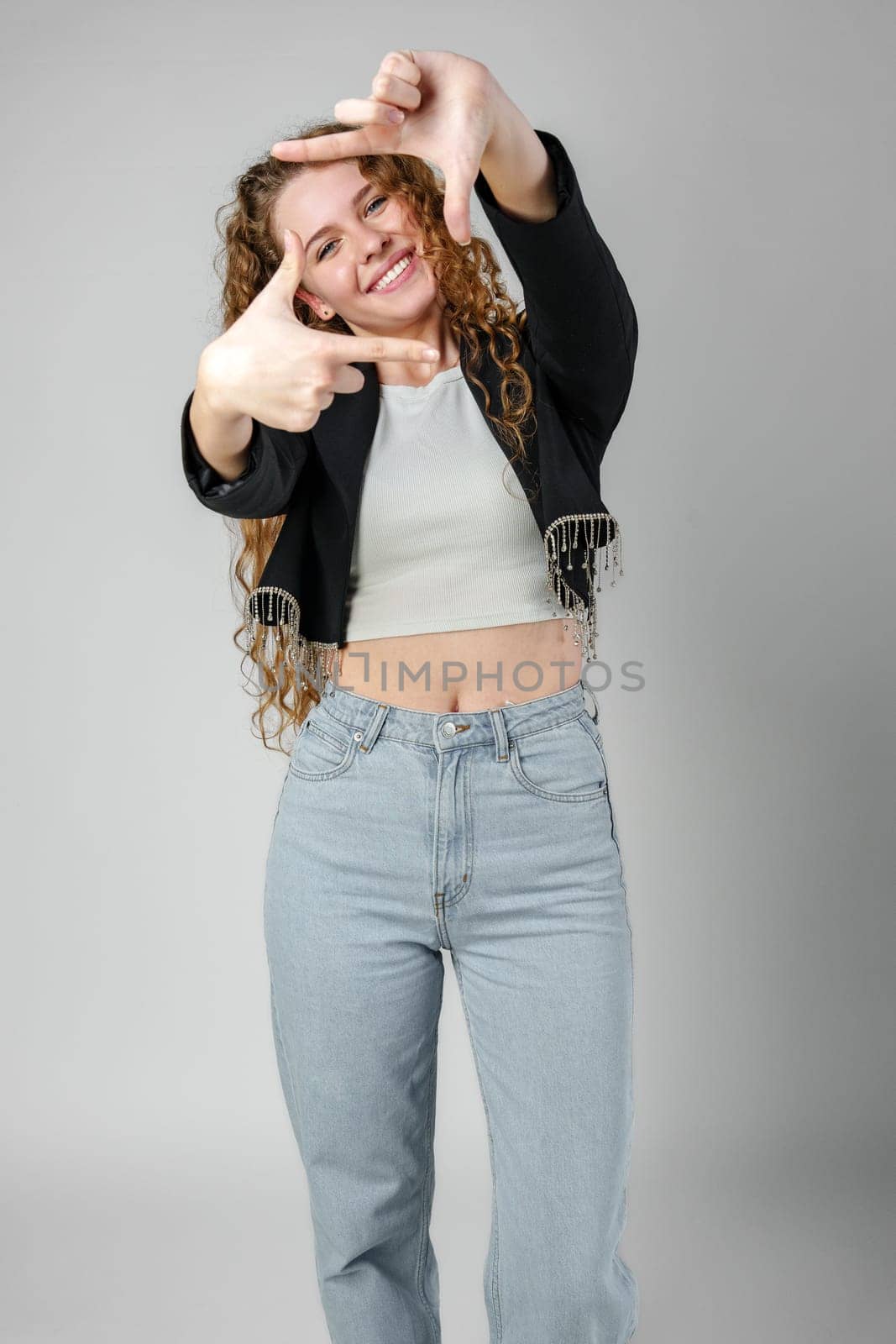 Woman Making Hand Gesture Picture Frame in Studio close up