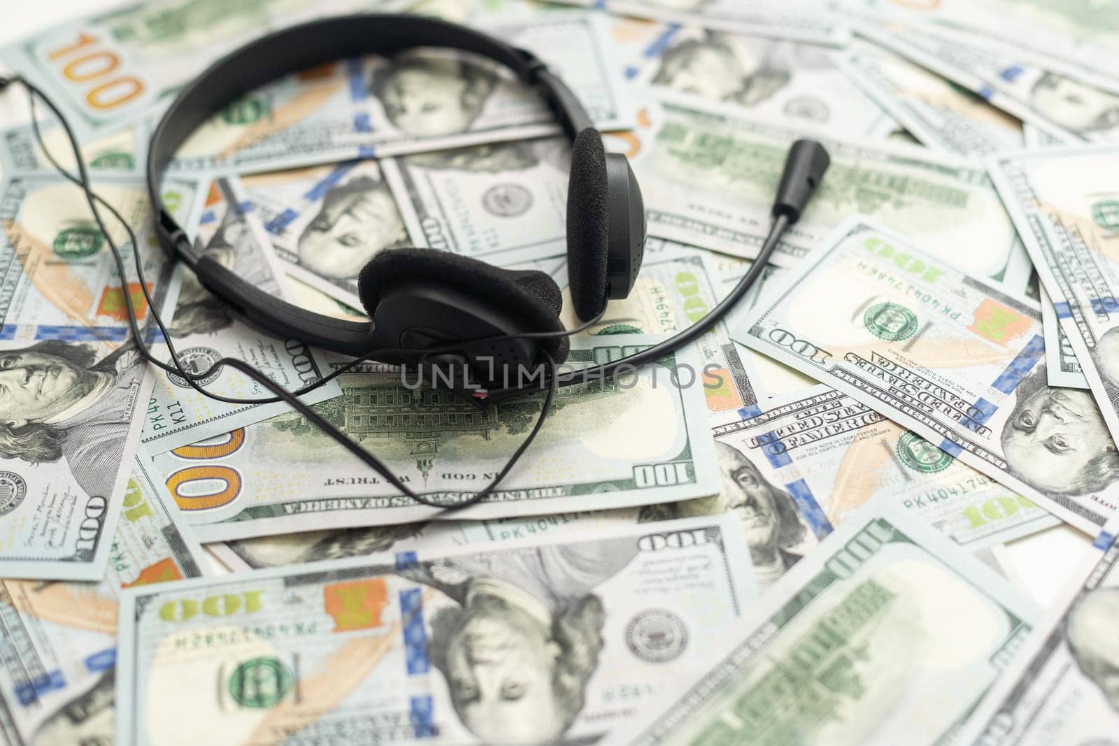 Headphones and American cash money on table. High quality photo