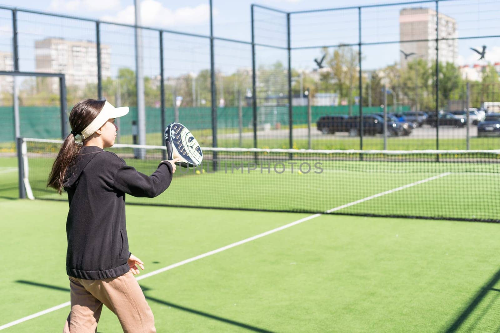 Ukraine Kyiv, April 20 2024. happy pretty girl practicing paddle sport on the paddle court. High quality photo