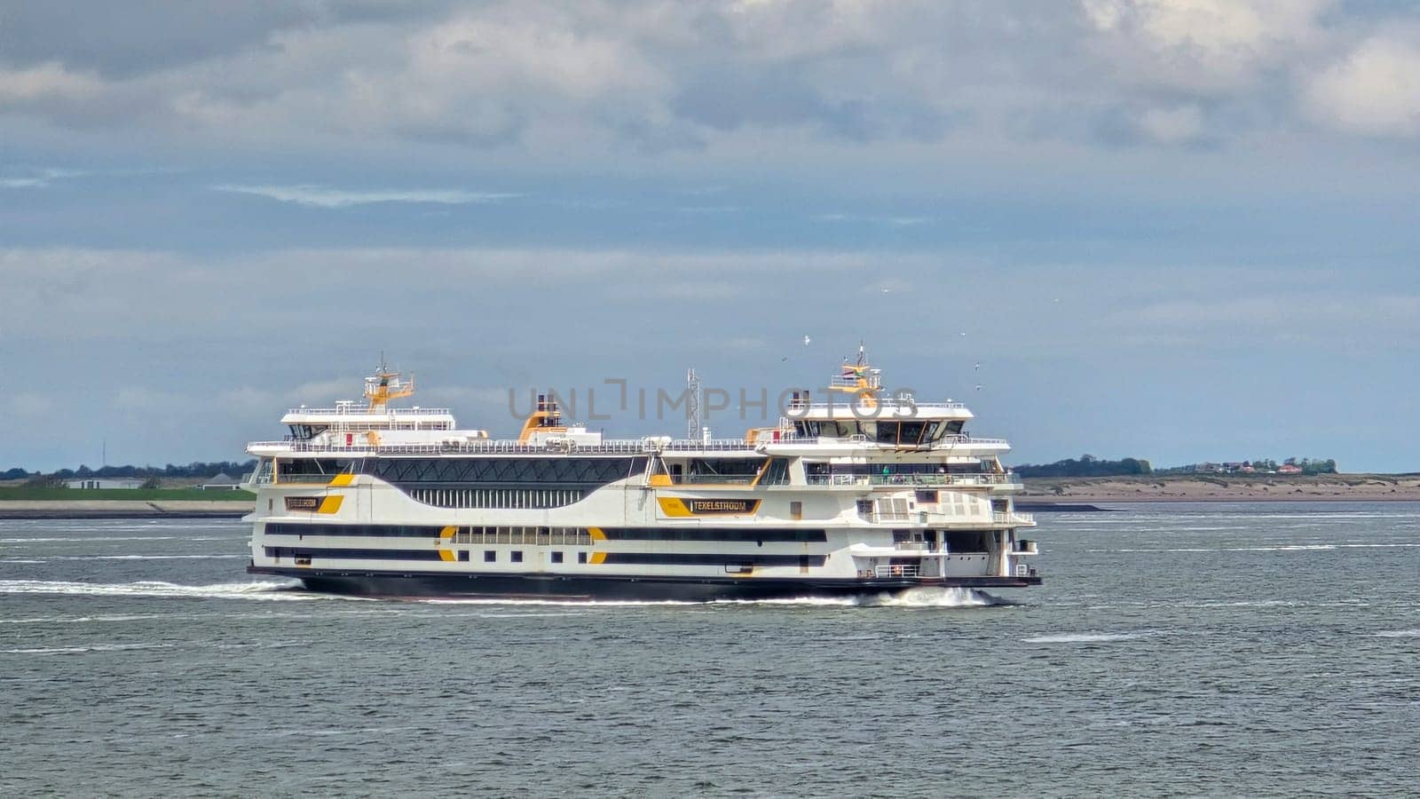 Texel Netherlands 12 May 2024,, A grand ferry glides gracefully across the waters near Texel, Netherlands, carrying passengers on a scenic journey.