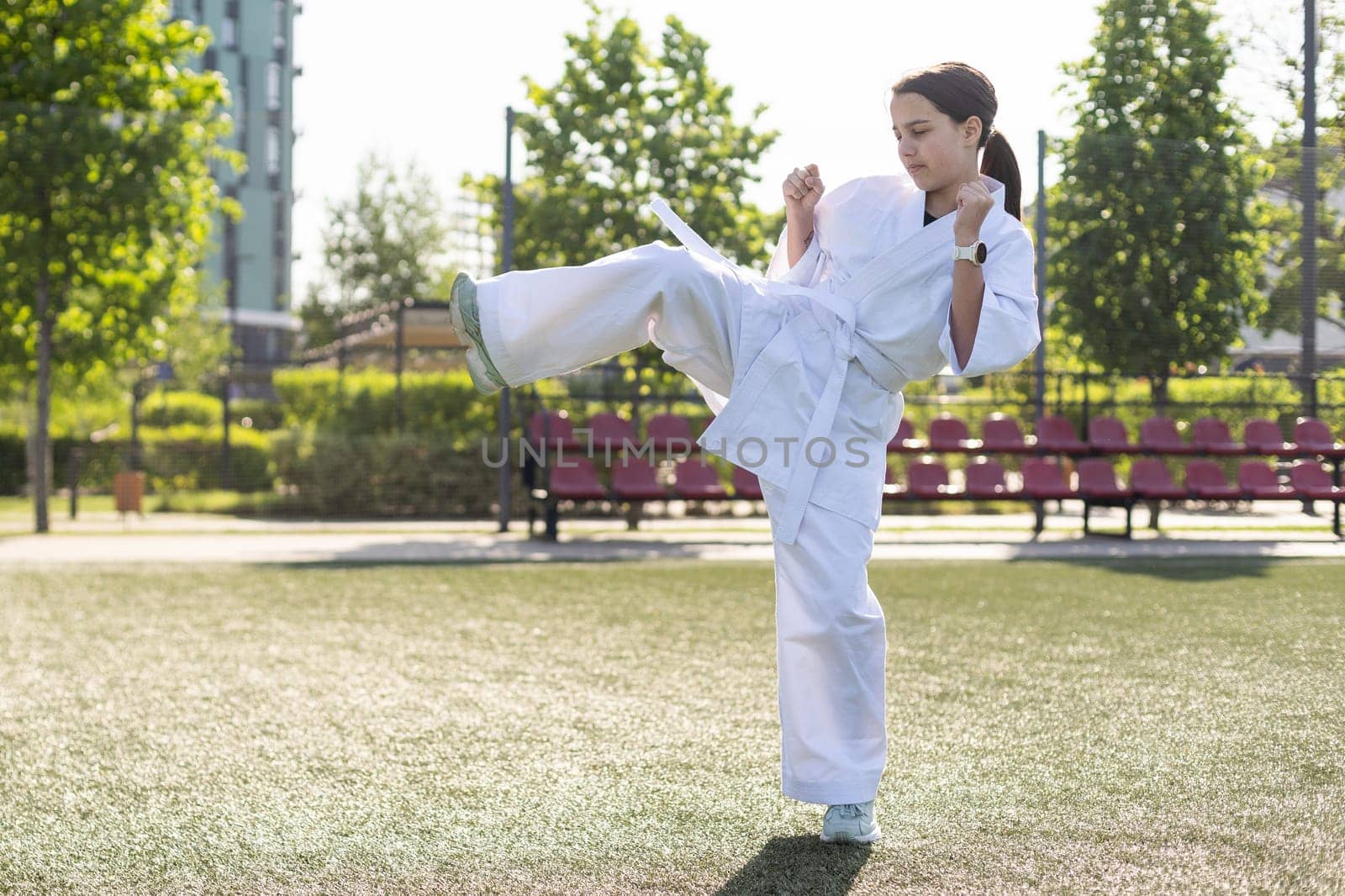 young girl in a white kimono, karate. High quality photo