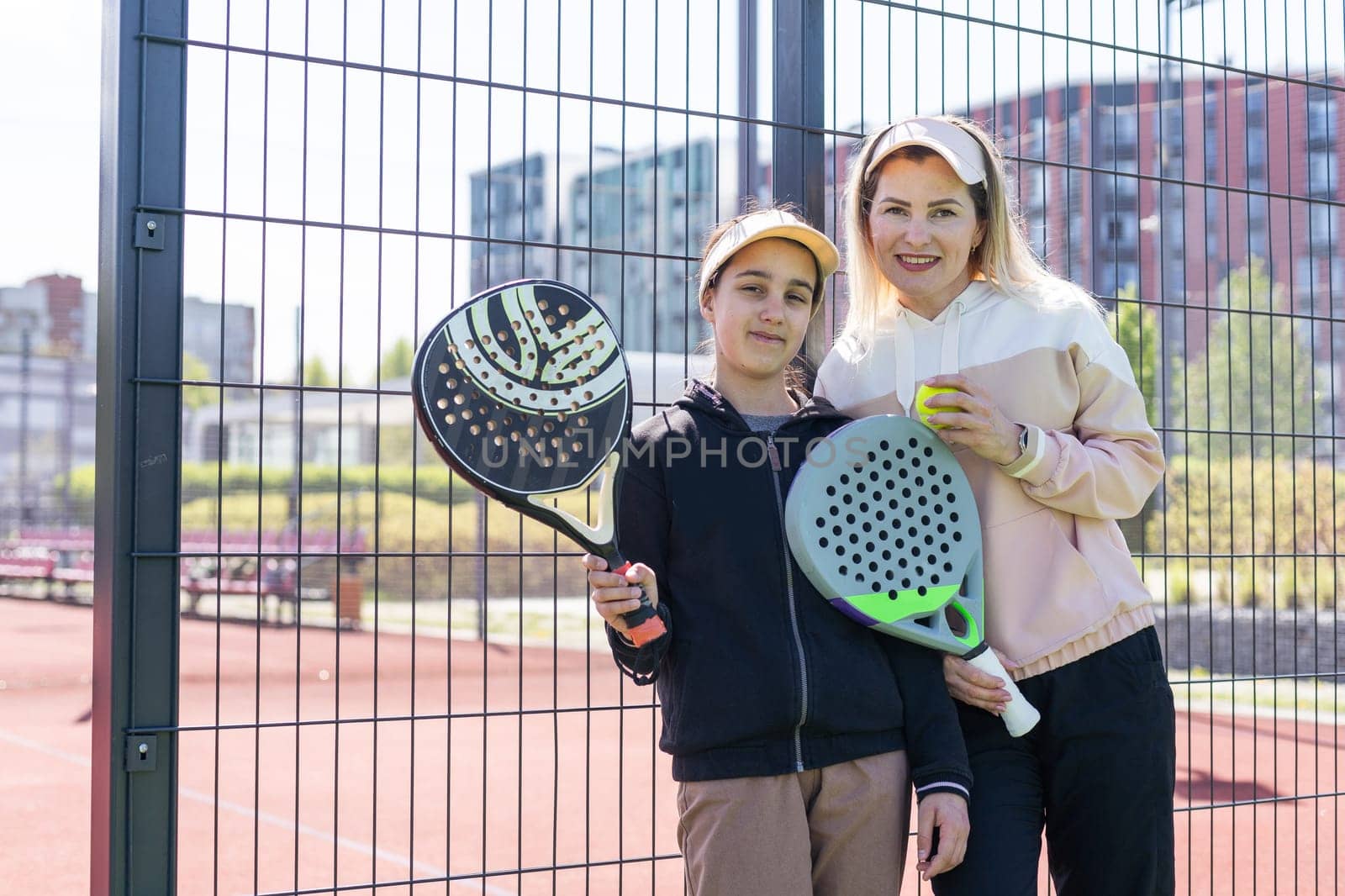 mother and daughter playing padel outdoor. High quality photo