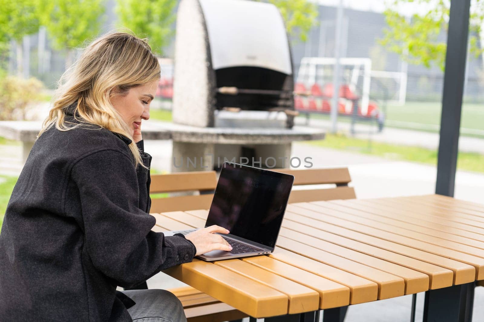 Young woman working at a remote job in a cafe. High quality photo