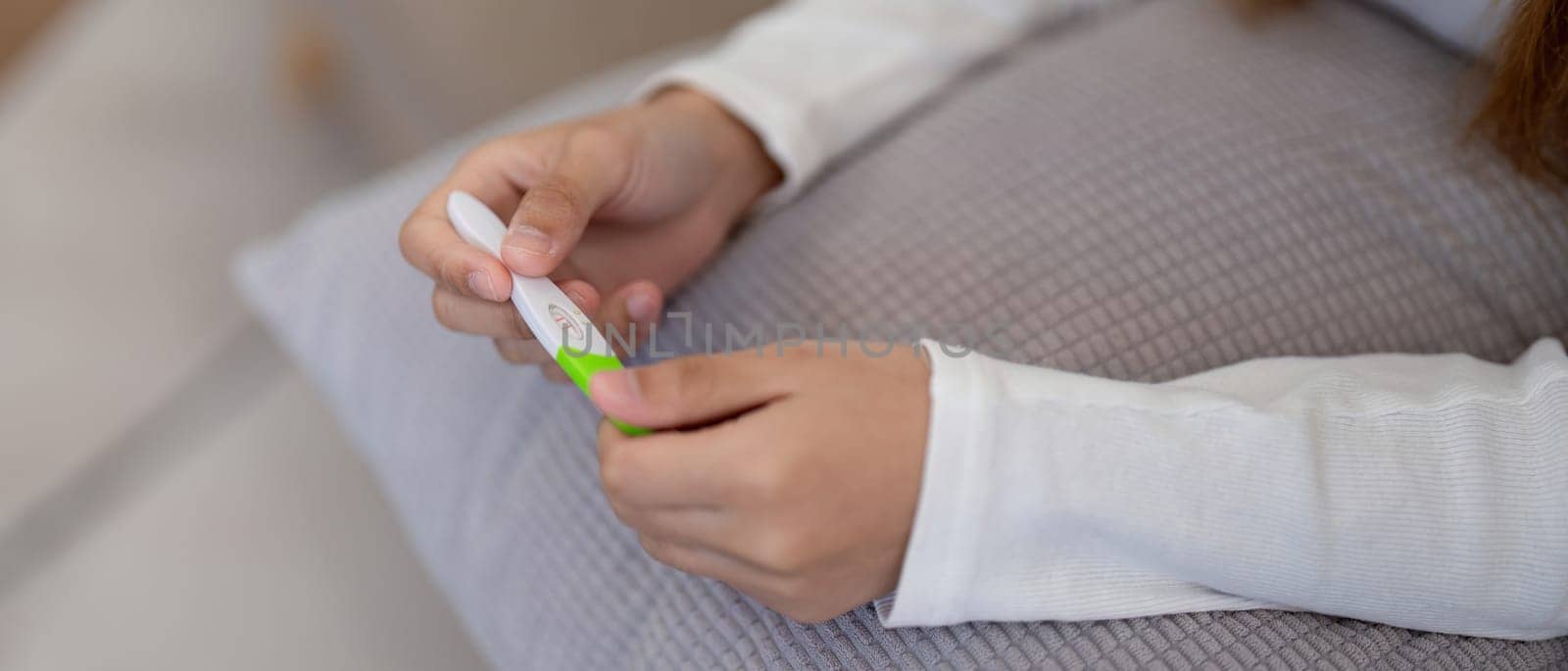 Woman examining pregnancy test results with concern. Concept of personal health, anxiety, and reproductive issues.