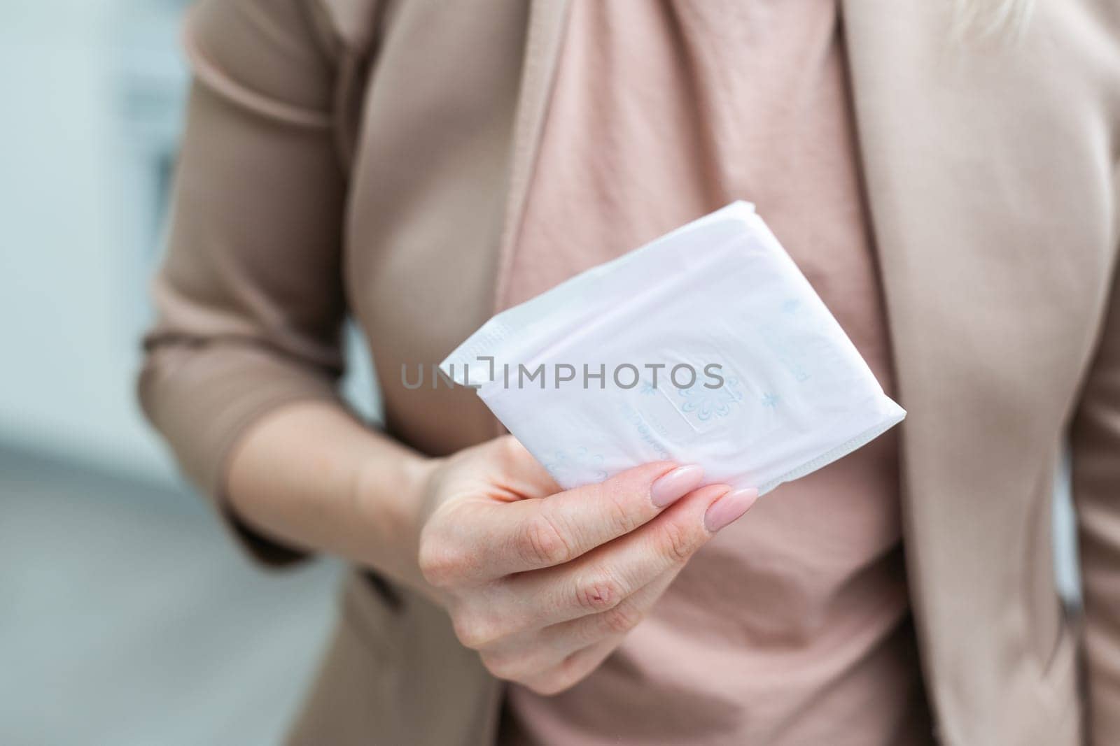 woman wearing a colored shirt holding a sanitary pad. High quality photo