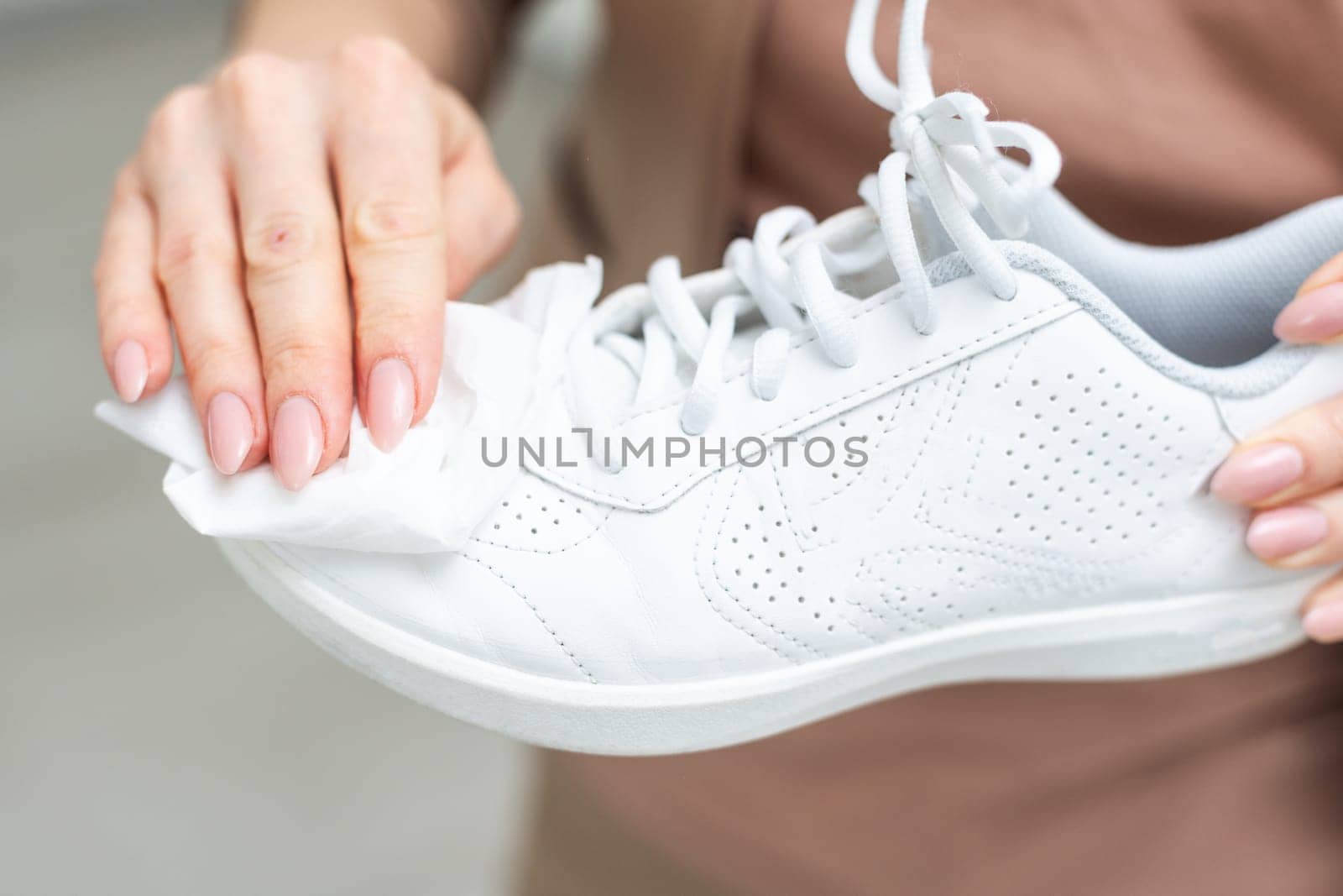 Cleaning white sneaker with cloth. High quality photo