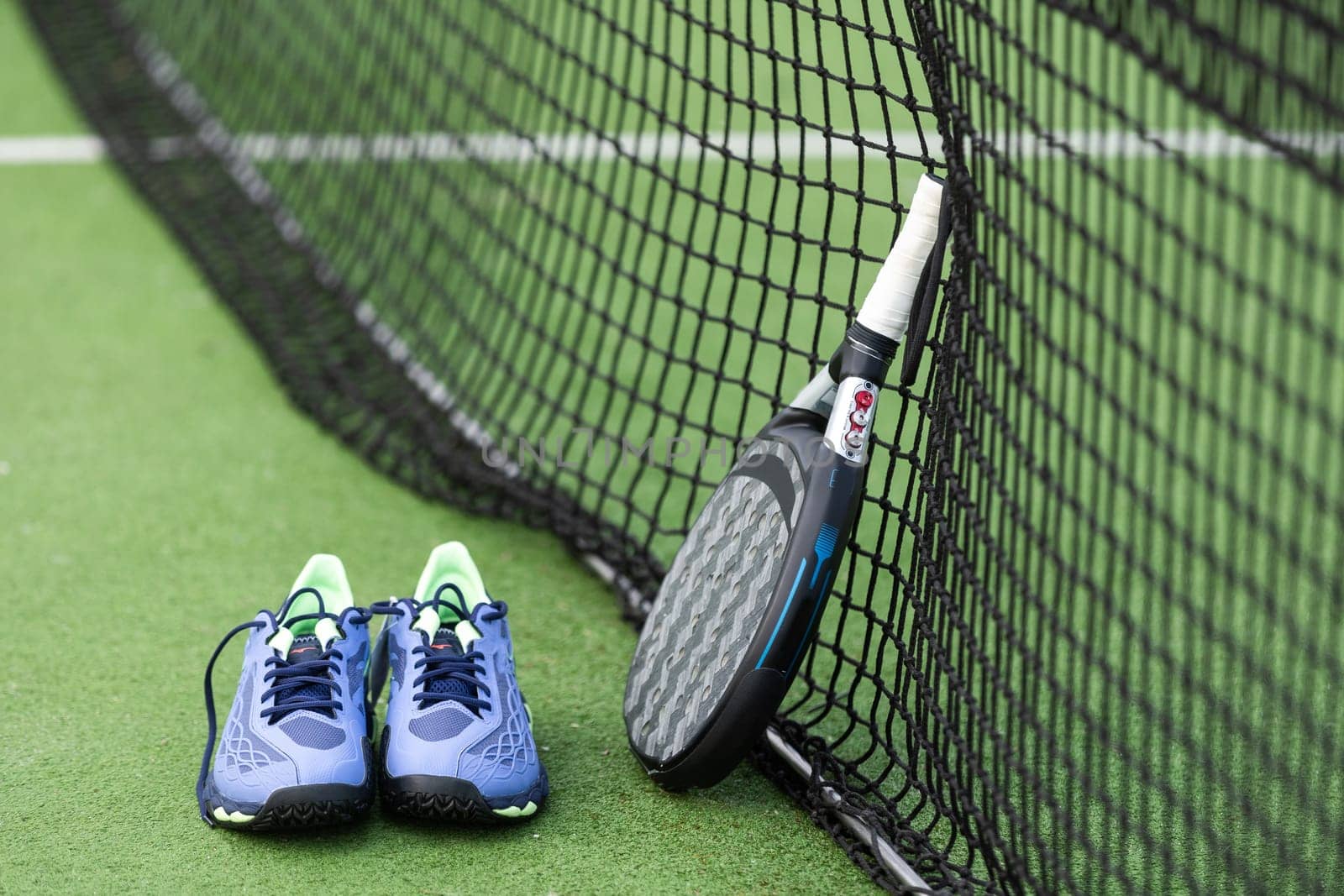 Padel tennis racket sport court and balls. Download a high quality photo with paddle for the design of a sports app or soical media advertisement. High quality photo