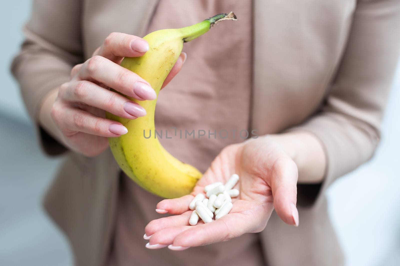 woman holding in hands spotty bananas and pills. High quality photo