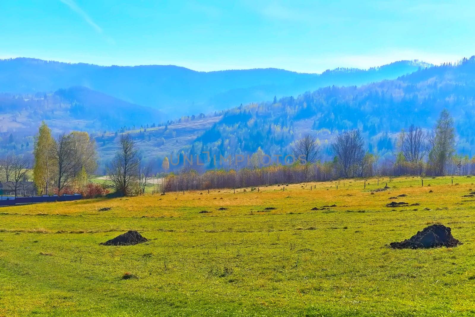 Mountain rural landscape with pasture,mountains in blue haze by jovani68