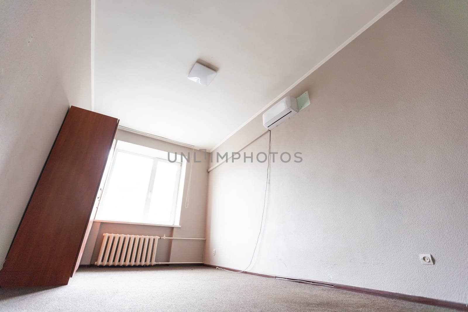 Empty room with all white walls and parquet floor. Nobody inside the room. High quality photo