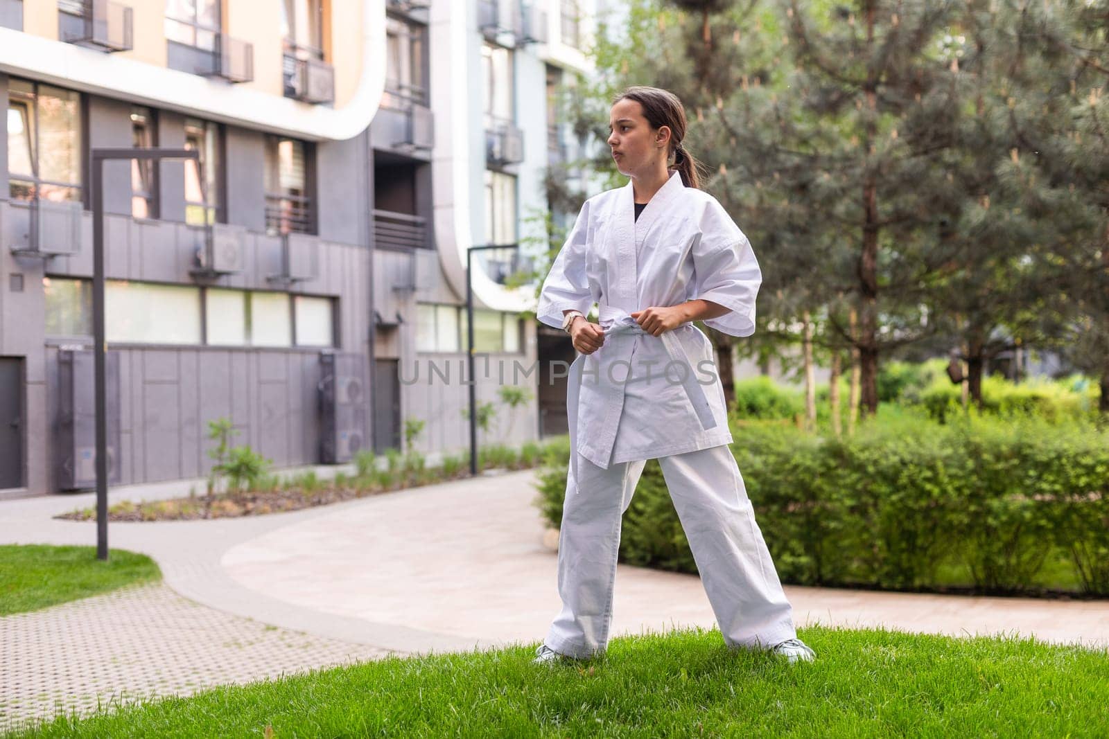 young girl in a white kimono, karate. High quality photo