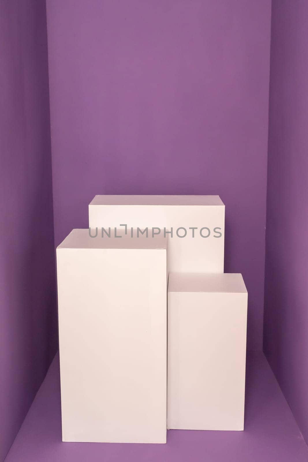 Three white rectangular boxes against purple background. Product photography mockup. High quality photo
