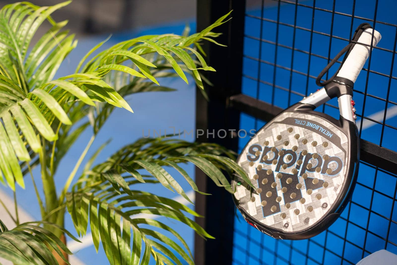 Kyiv, Ukraine. March 22, 2024 paddle tennis objects in court, racket, balls and fences outdoors, focus on fence. High quality photo