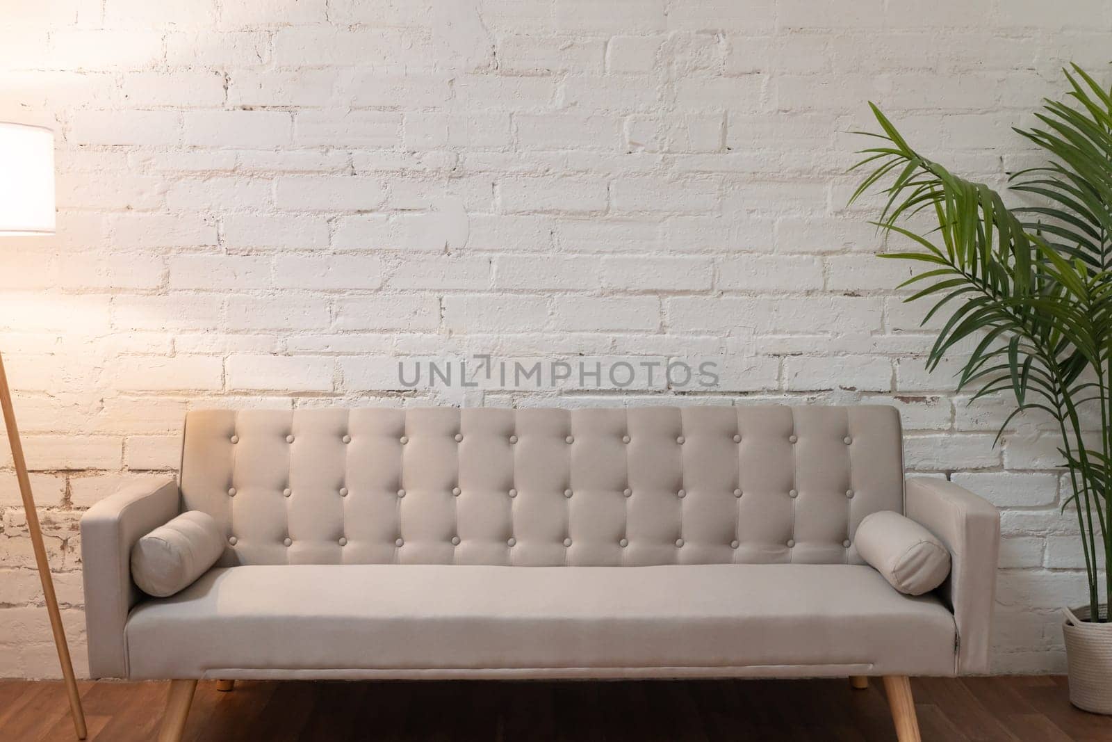 Sofa over white brick wall with copy space by PaulCarr