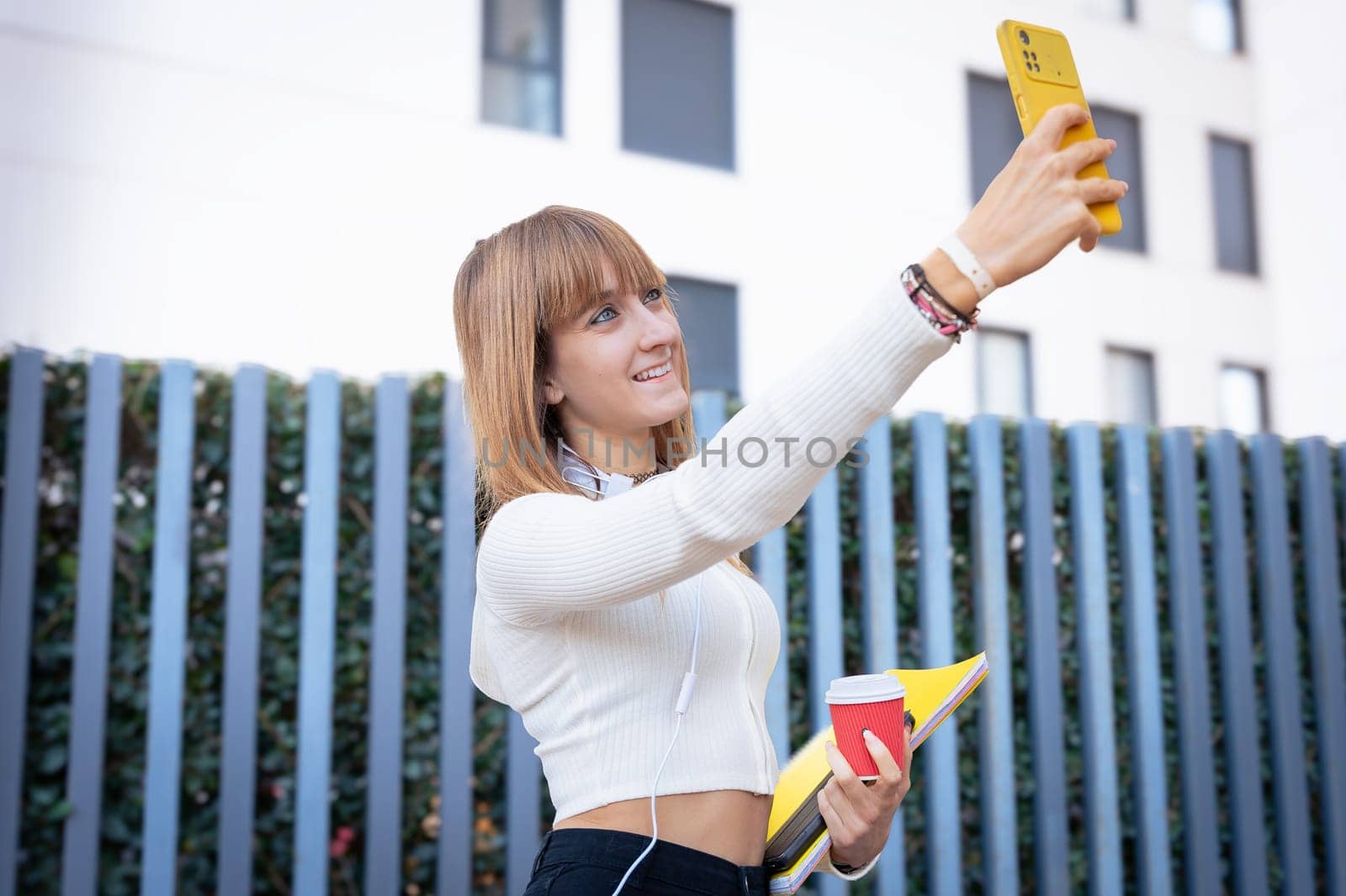 Happy young woman taking a selfie with smartphone