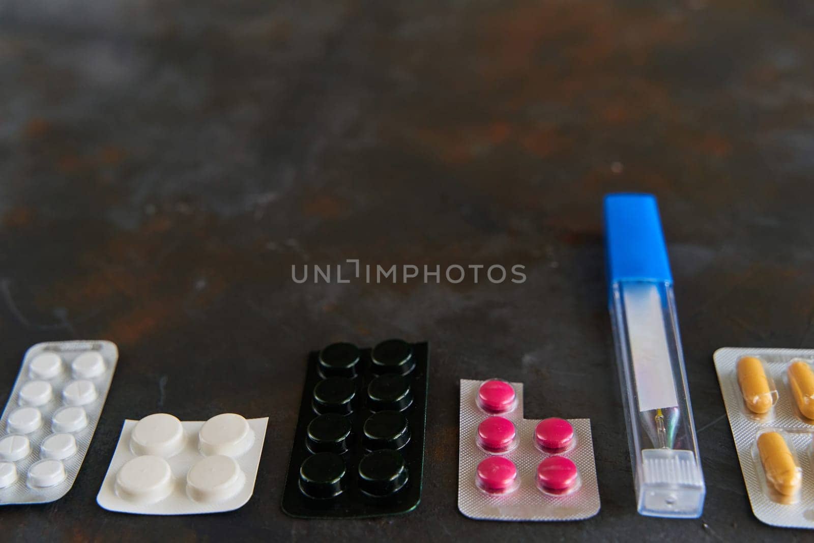 Pills capsules medicine health on dark background top view, medical pharmacy concept. Different pills on dark background with copy space.