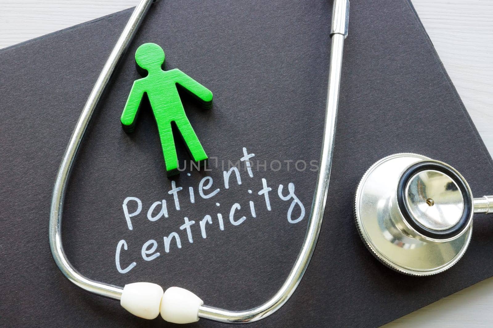 Patient centricity concept. Figurine and stethoscope on notepad.