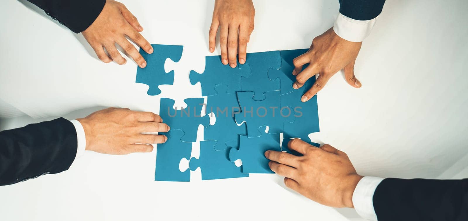 Top view panorama banner of business team assembling jigsaw puzzle over table symbolize business partnership and collective teamwork for HR recruitment and job seeker background. Shrewd