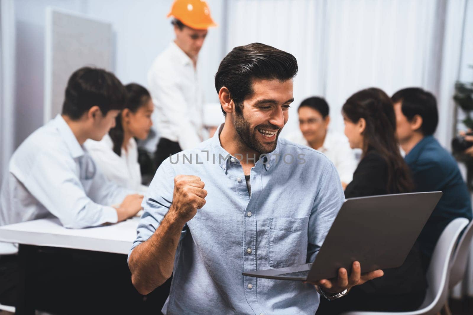 Engineer team leader portrait with diverse group of civil engineer and client working together on architectural project, reviewing construction plan and building blueprint at meeting table. Prudent