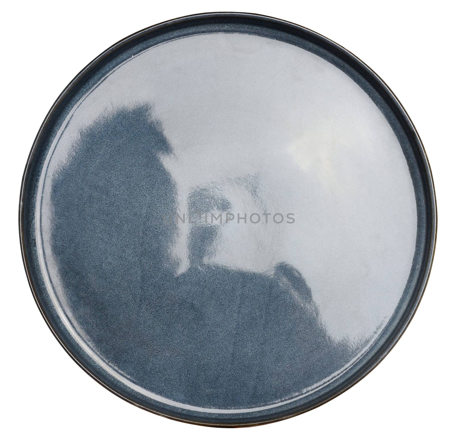 Empty blue ceramic plate on isolated background, top view by ndanko