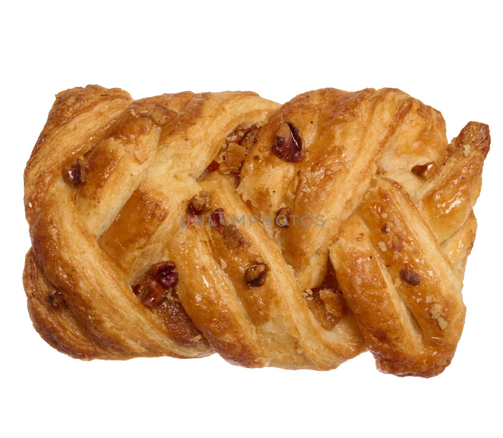 Puff pastry with pecans and maple syrup on a white background, top view