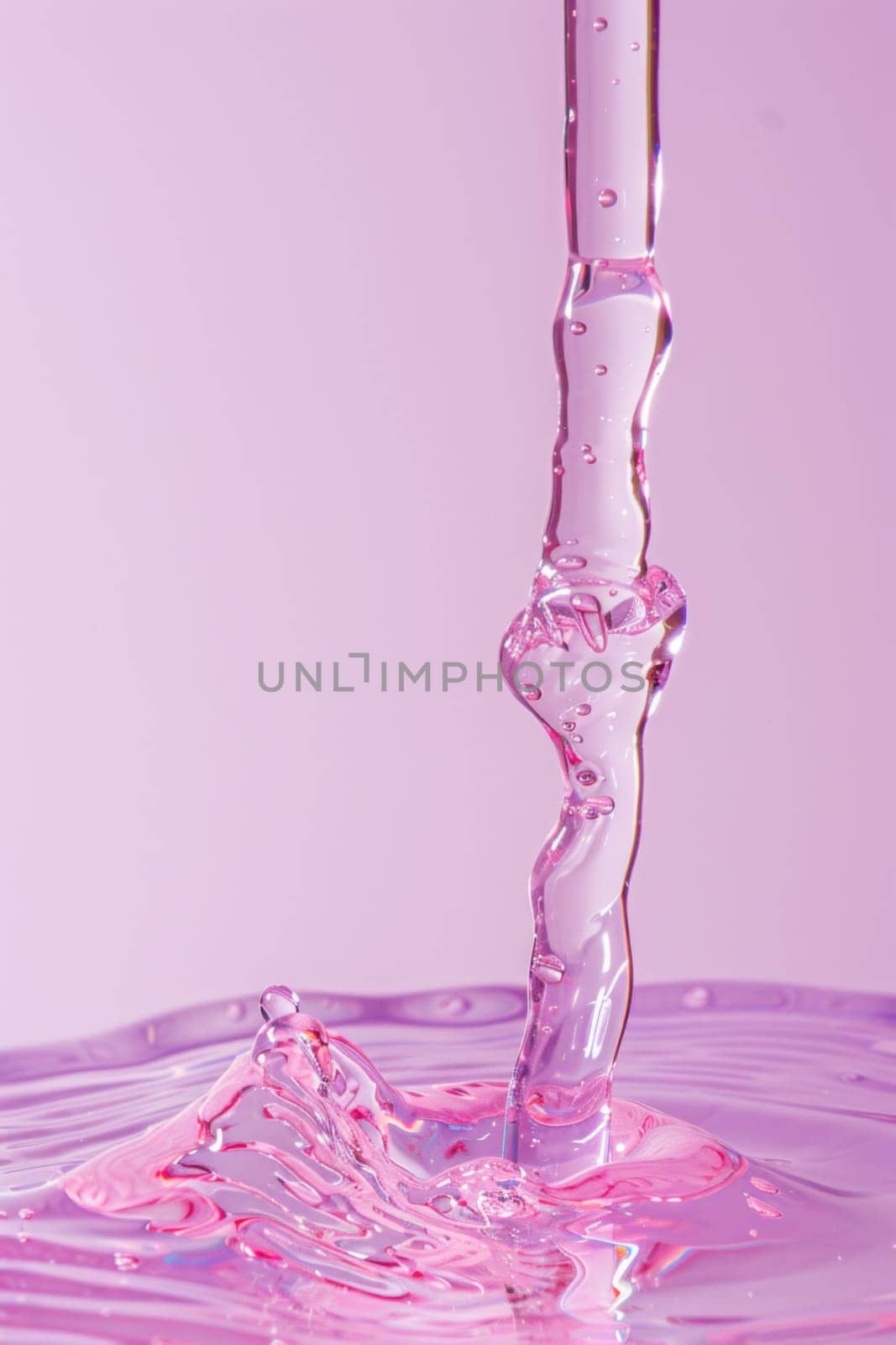 Pink liquid pouring into glass with purple and pink background, conceptual image of beauty and elegance by Vichizh