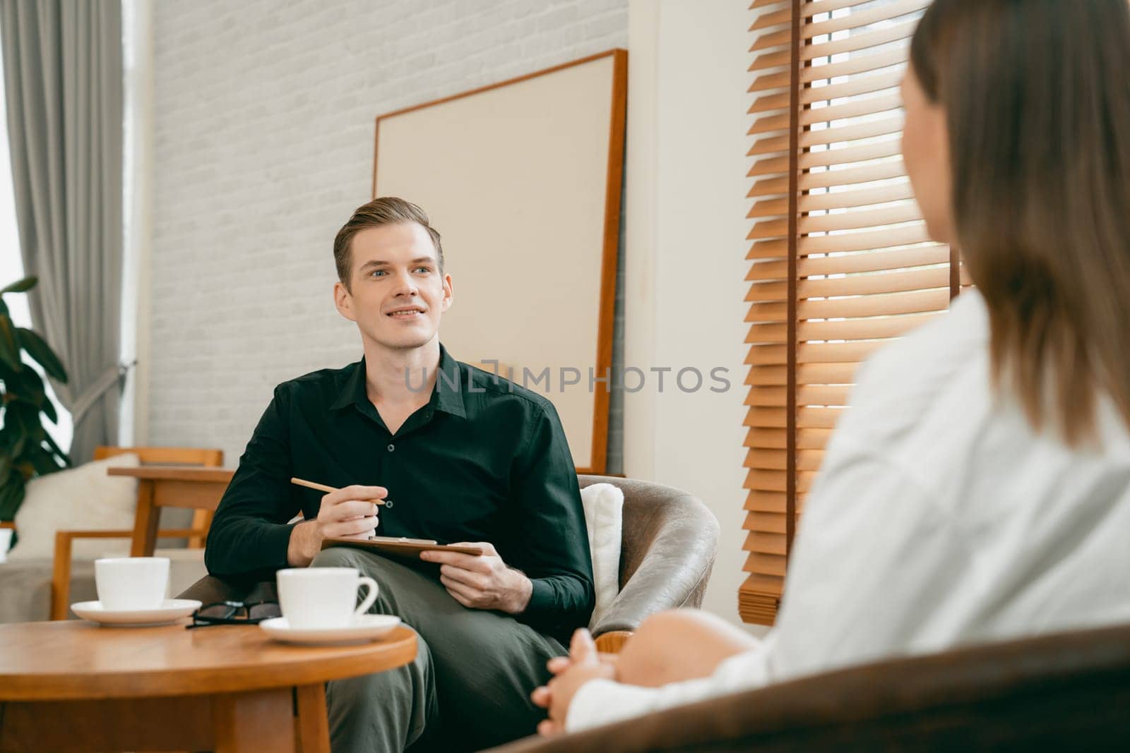 Psychological consultation gaining improvement on mental problem, happy young female patient doing therapy session while psychiatrist making diagnostic on mental illness. Unveiling