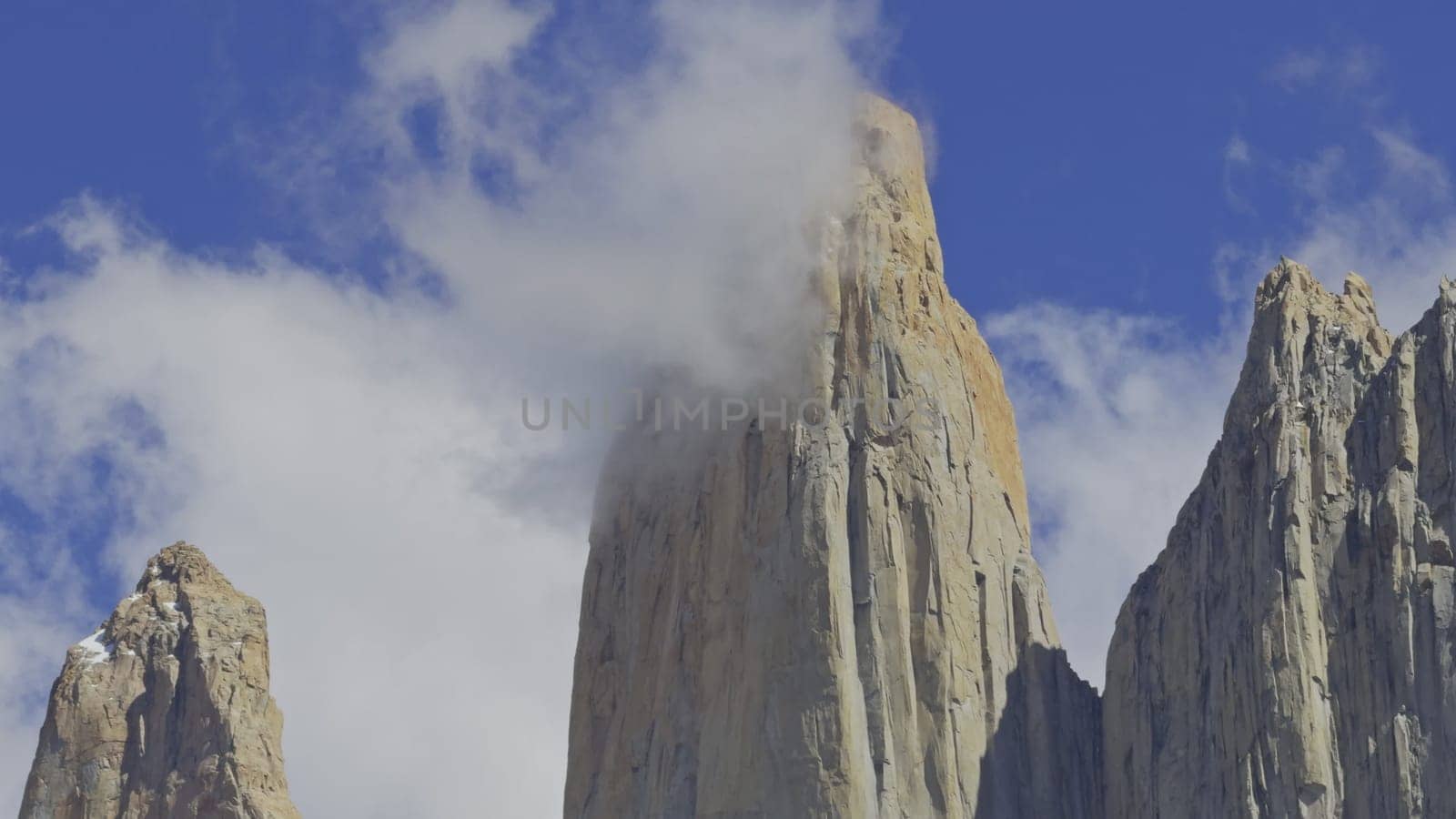 Torres del Paine summit video shows the iconic peaks piercing through clouds above the park.