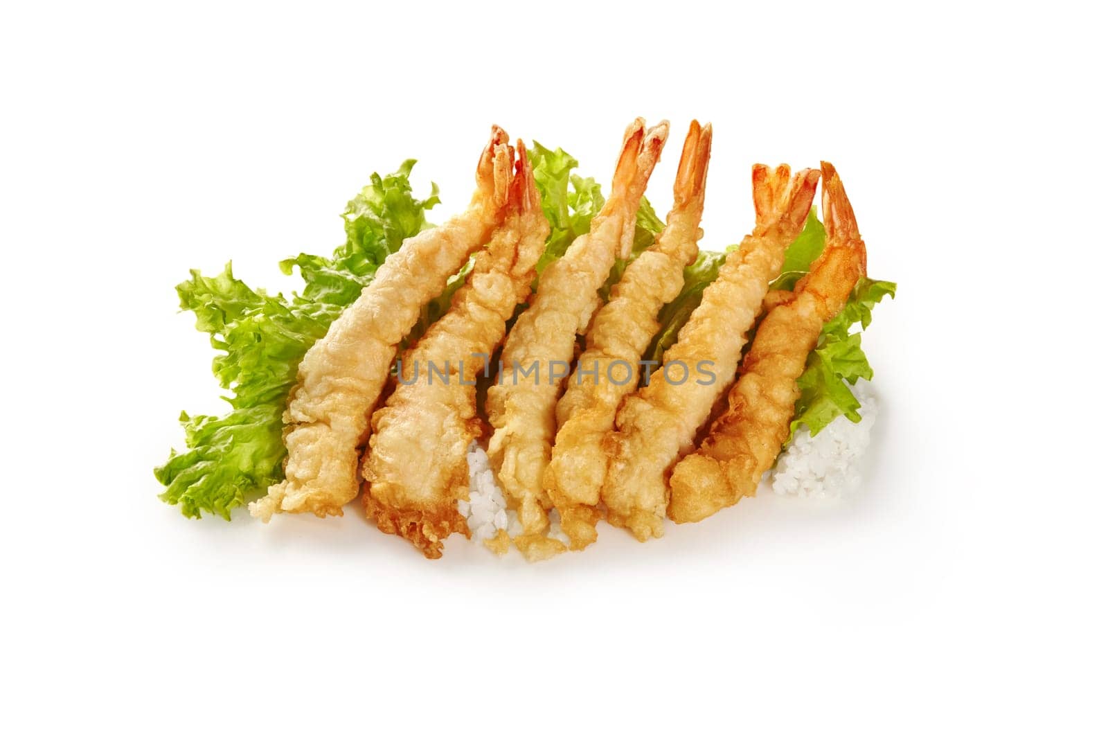 Appetizing golden shrimp tempura lined atop bed of rice and fresh green lettuce isolated on white background. Concept of Japanese inspired meal