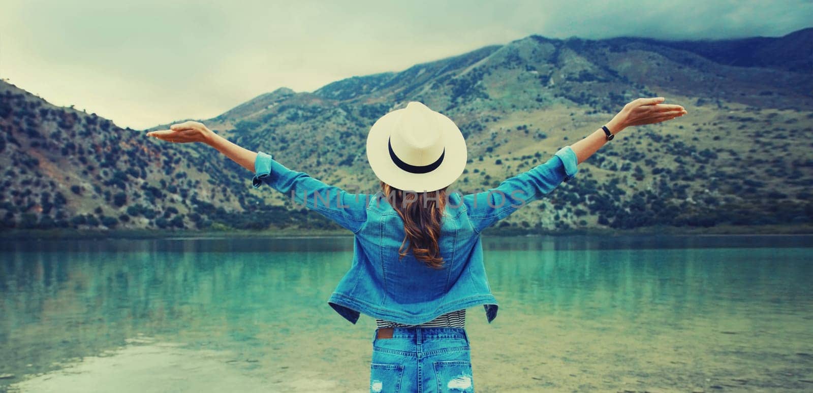 Summer vacation tourism, happy woman tourist on lake and mountains background by Rohappy