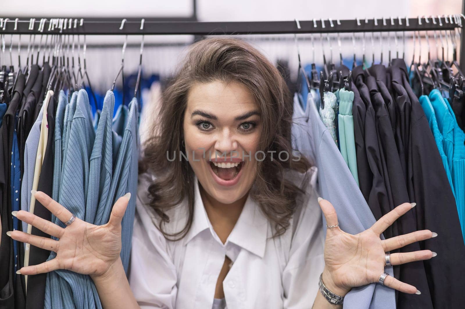Smiling fat woman in plus size store looking at camera