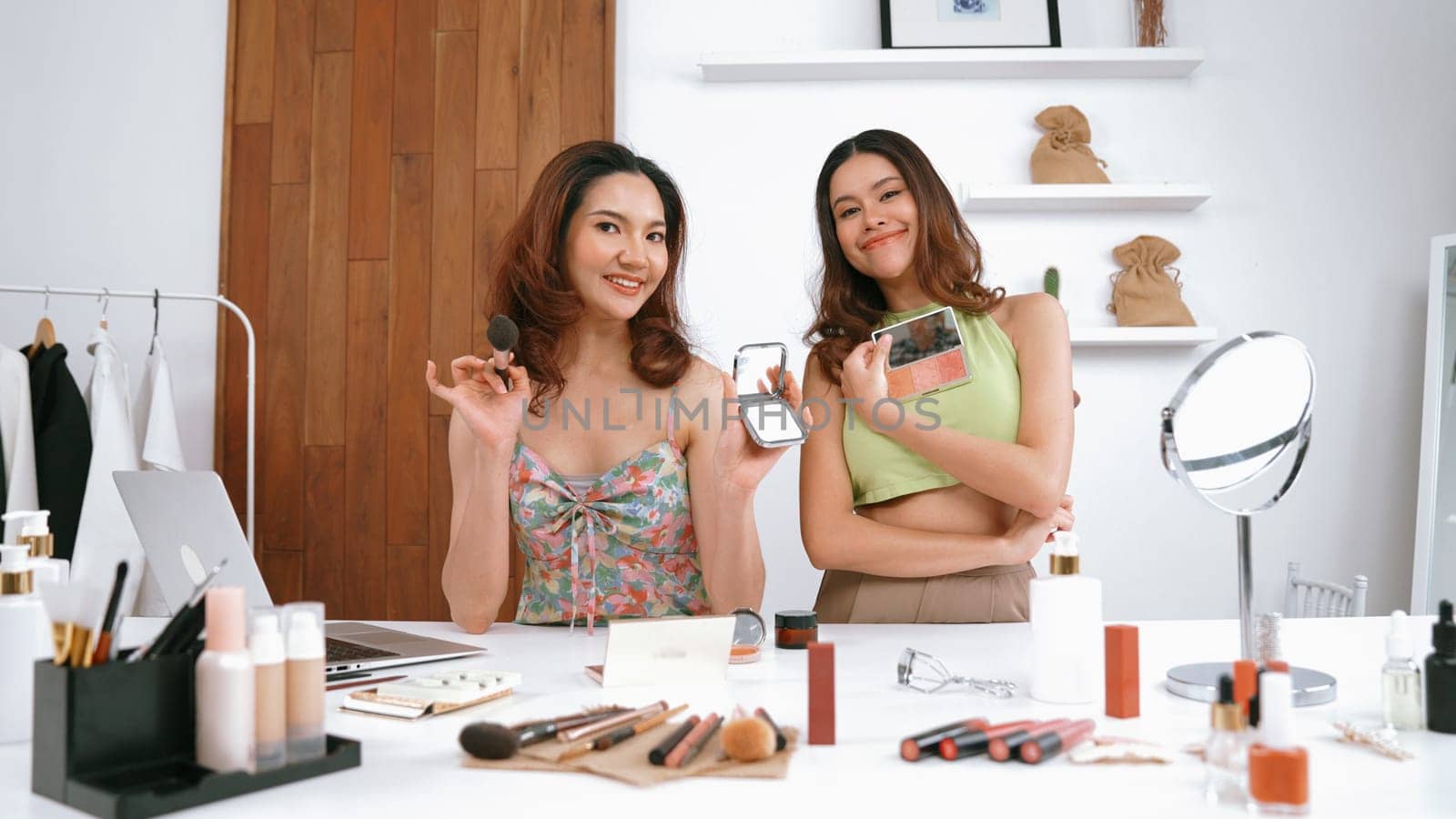 Two influencer partner shoot live streaming vlog video review makeup social media or blog. Happy young girl with vivancy cosmetics studio lighting for marketing recording session broadcasting online.