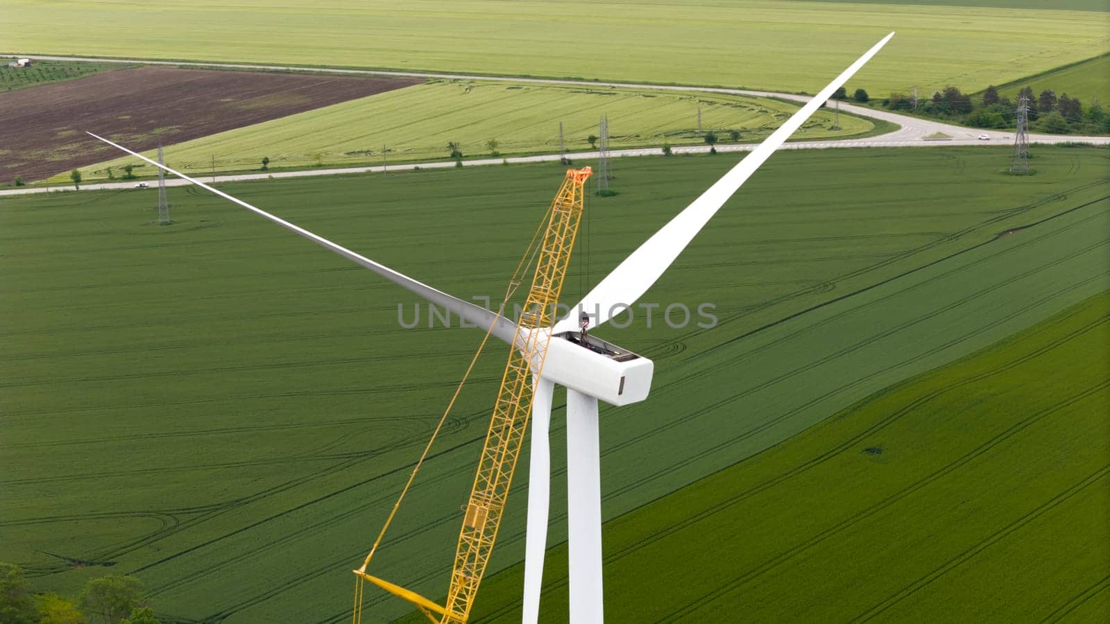 carbon neutral electricity power. Aerial view of green meadows with renewable energy wind turbine