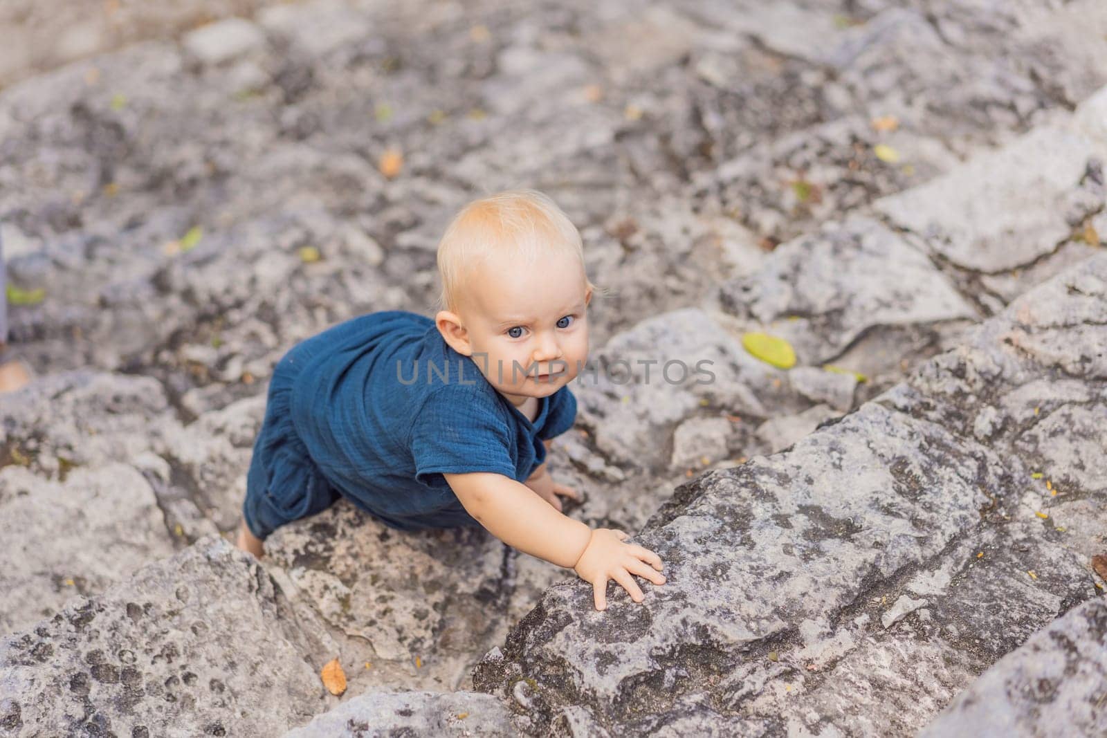 Baby tourist at Coba, Mexico. Ancient mayan city in Mexico. Coba is an archaeological area and a famous landmark of Yucatan Peninsula. Cloudy sky over a pyramid in Mexico.