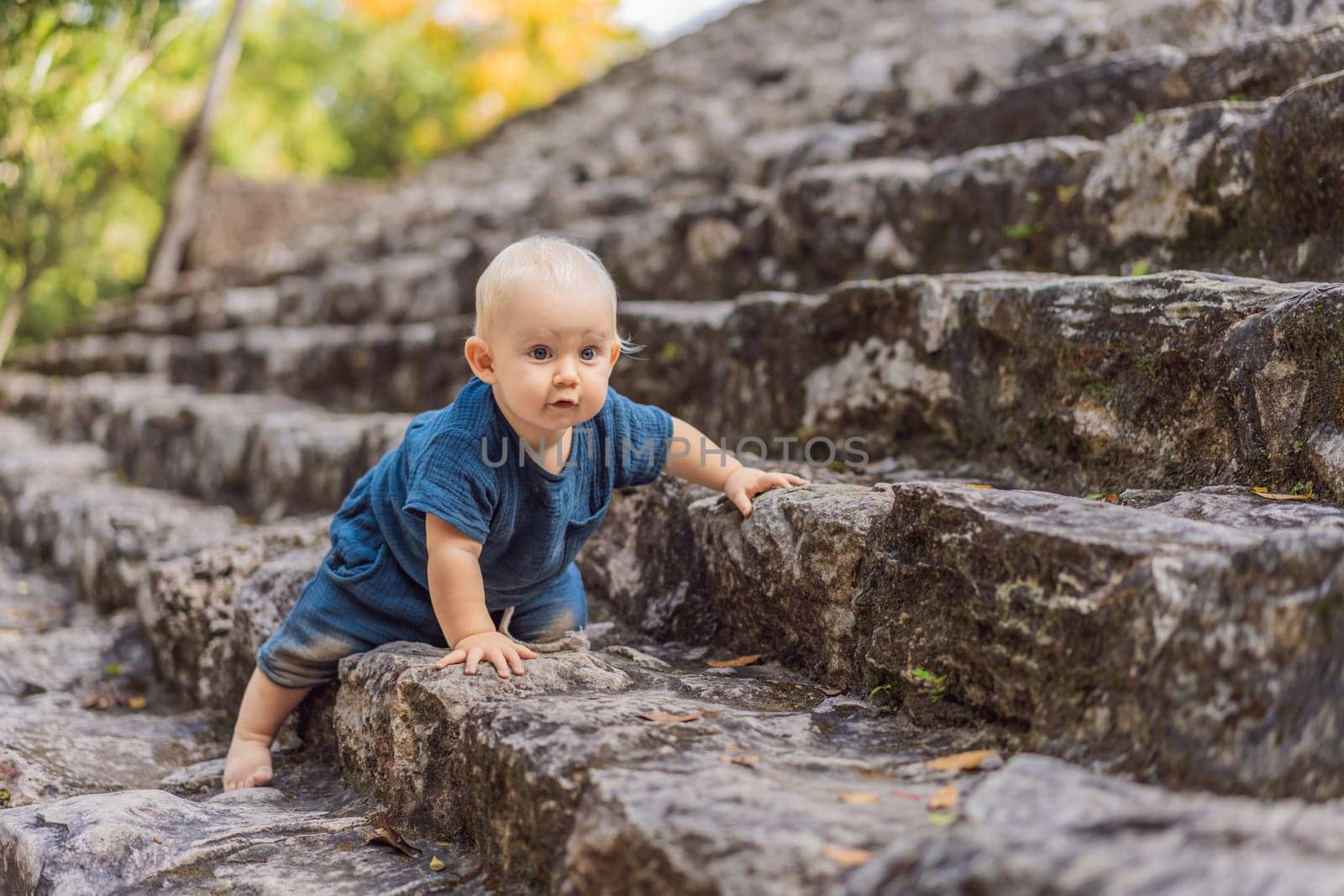 Baby tourist at Coba, Mexico. Ancient mayan city in Mexico. Coba is an archaeological area and a famous landmark of Yucatan Peninsula. Cloudy sky over a pyramid in Mexico.