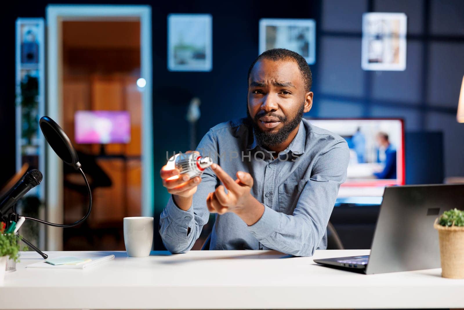 Internet show host being sponsored by partnering brand to do smart light bulb unboxing content. Tech specialist does influencer marketing, doing home automation device product placement