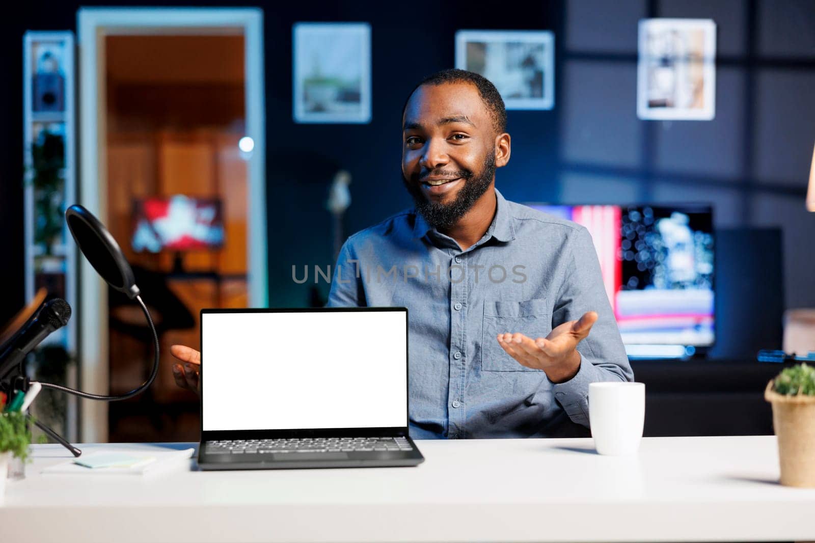 Internet show host being sponsored by partnering brand to do mockup laptop unboxing content. Tech specialist does influencer marketing, doing isolated screen notebook product placement