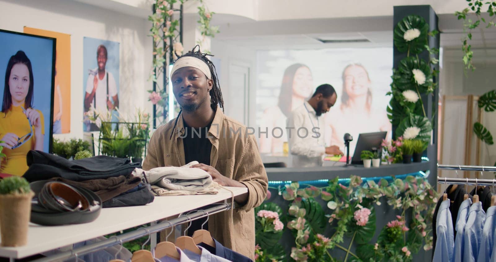 Portrait of client shopping in luxurious clothing store with elegant assortment of blazers. Customer buying clothes in premium fashion boutique with stylish attire garments