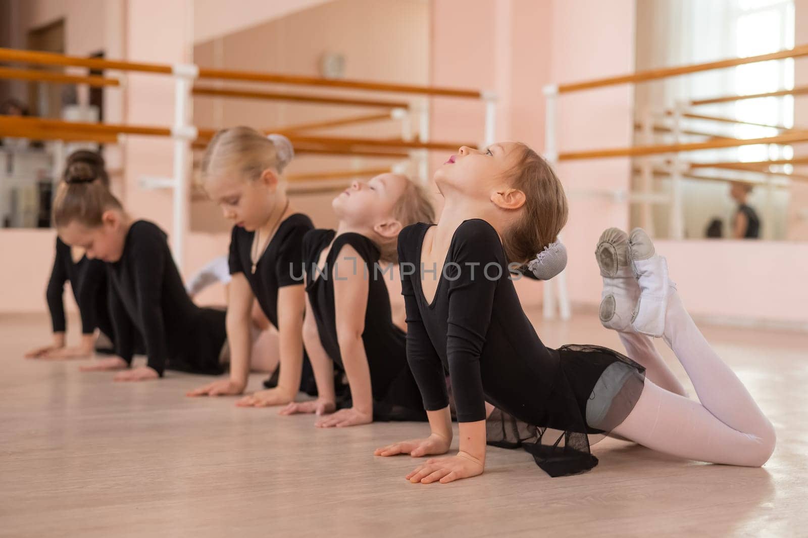 Five little girls doing basket exercise