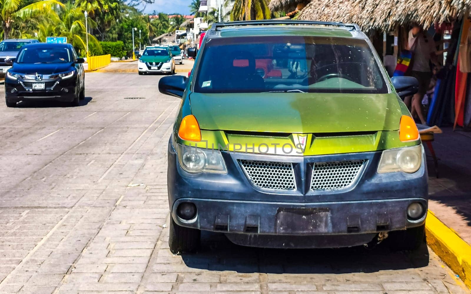 Green vintage retro classic car vehicle transportation in the city town in Zicatela Puerto Escondido Oaxaca Mexico.