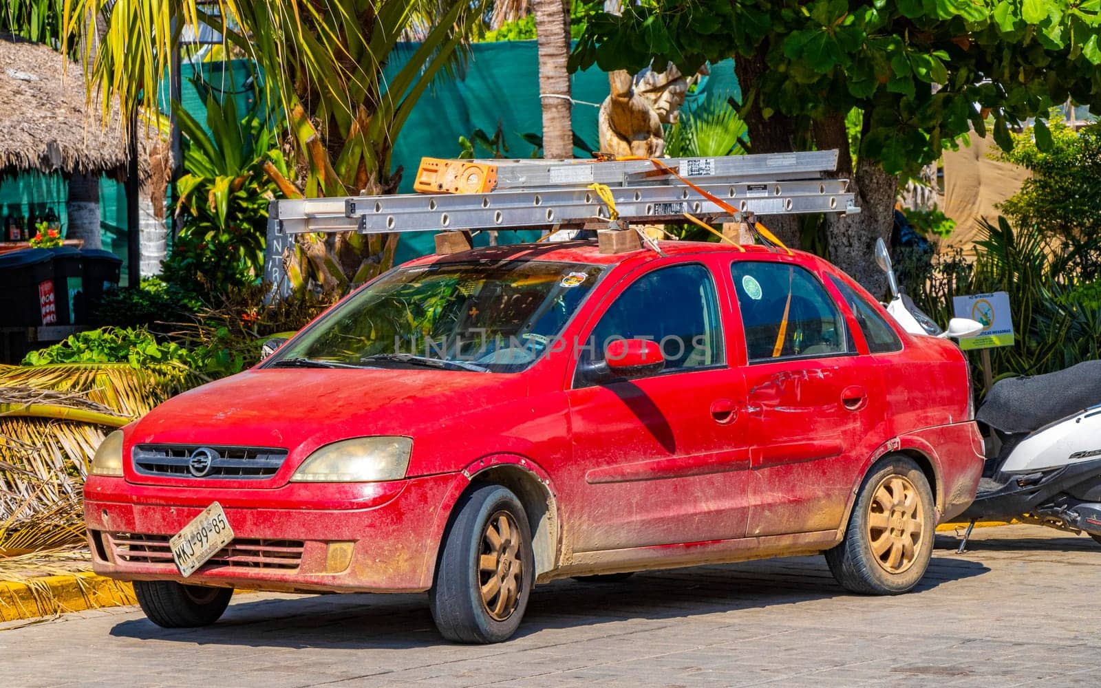 Red modern car vehicle transportation in the city town in Zicatela Puerto Escondido Oaxaca Mexico.