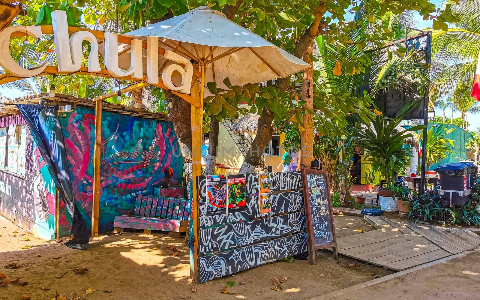 Restaurant restaurants bar bars shops hotels palms palm trees and promenades on the beach in Zicatela Puerto Escondido Oaxaca Mexico.