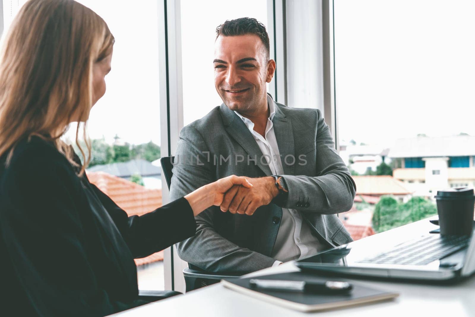 Businessman executive handshake with businesswoman worker in modern workplace office. People corporate business deals concept. uds