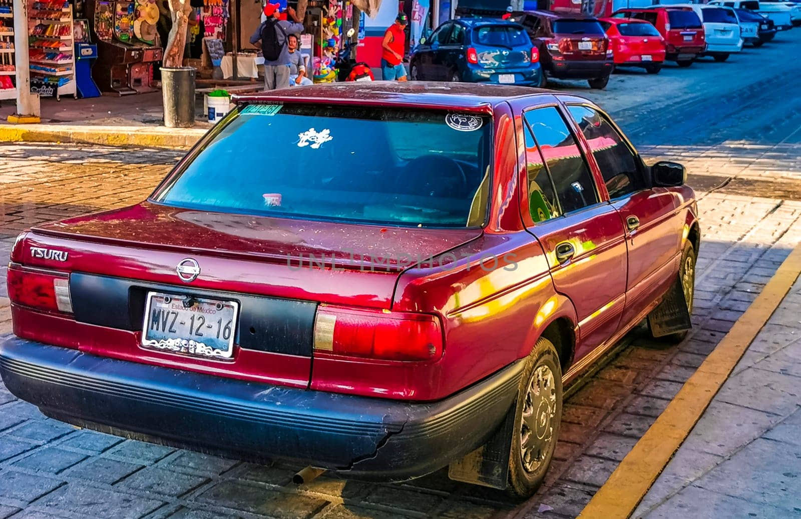 Red modern car vehicle transportation in the city town in Zicatela Puerto Escondido Oaxaca Mexico.