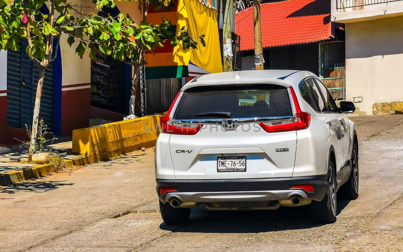 White silver gray grey car vehicle transportation in the city town in Zicatela Puerto Escondido Oaxaca Mexico.