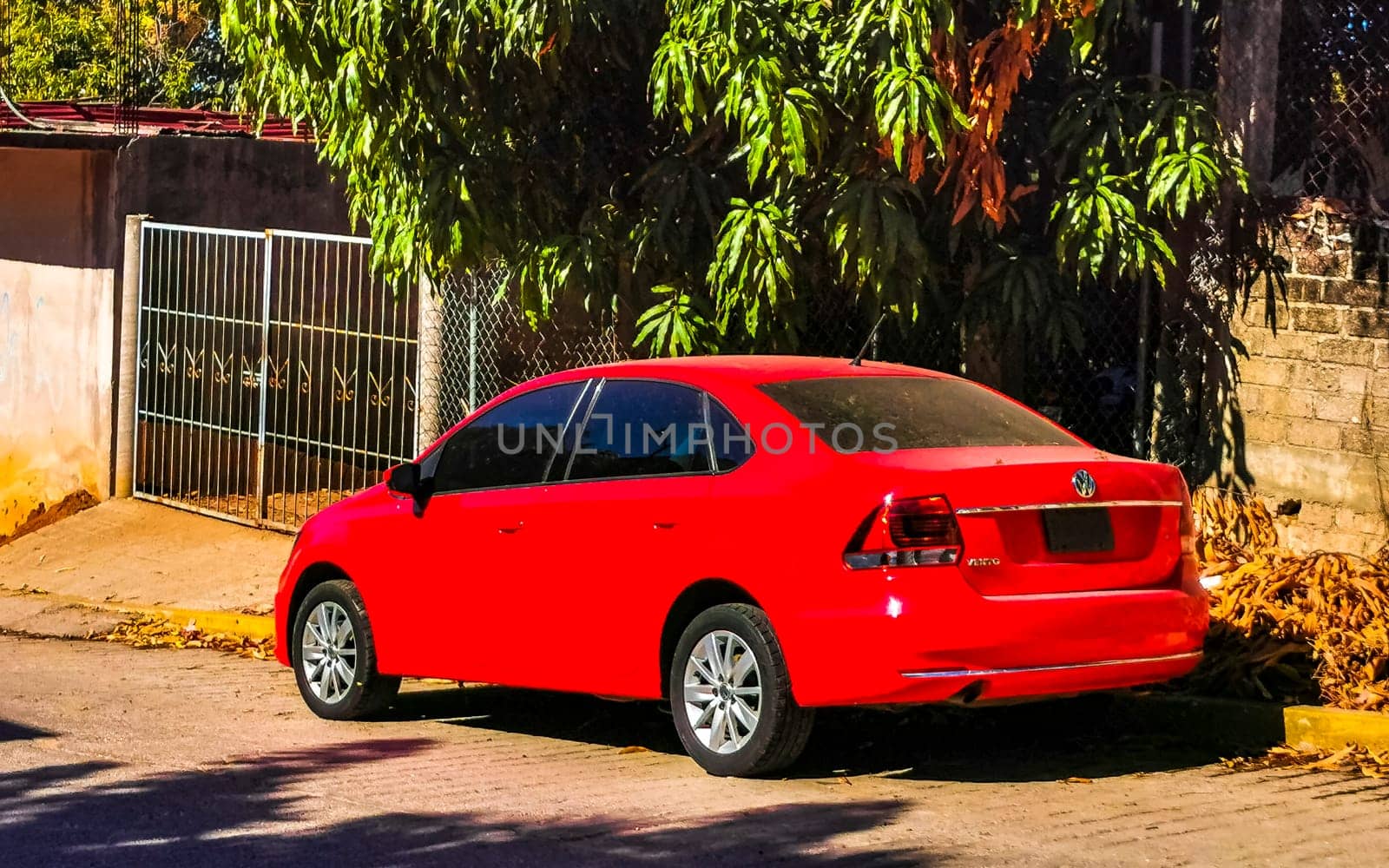 Red modern car vehicle transportation in the city town in Zicatela Puerto Escondido Oaxaca Mexico.