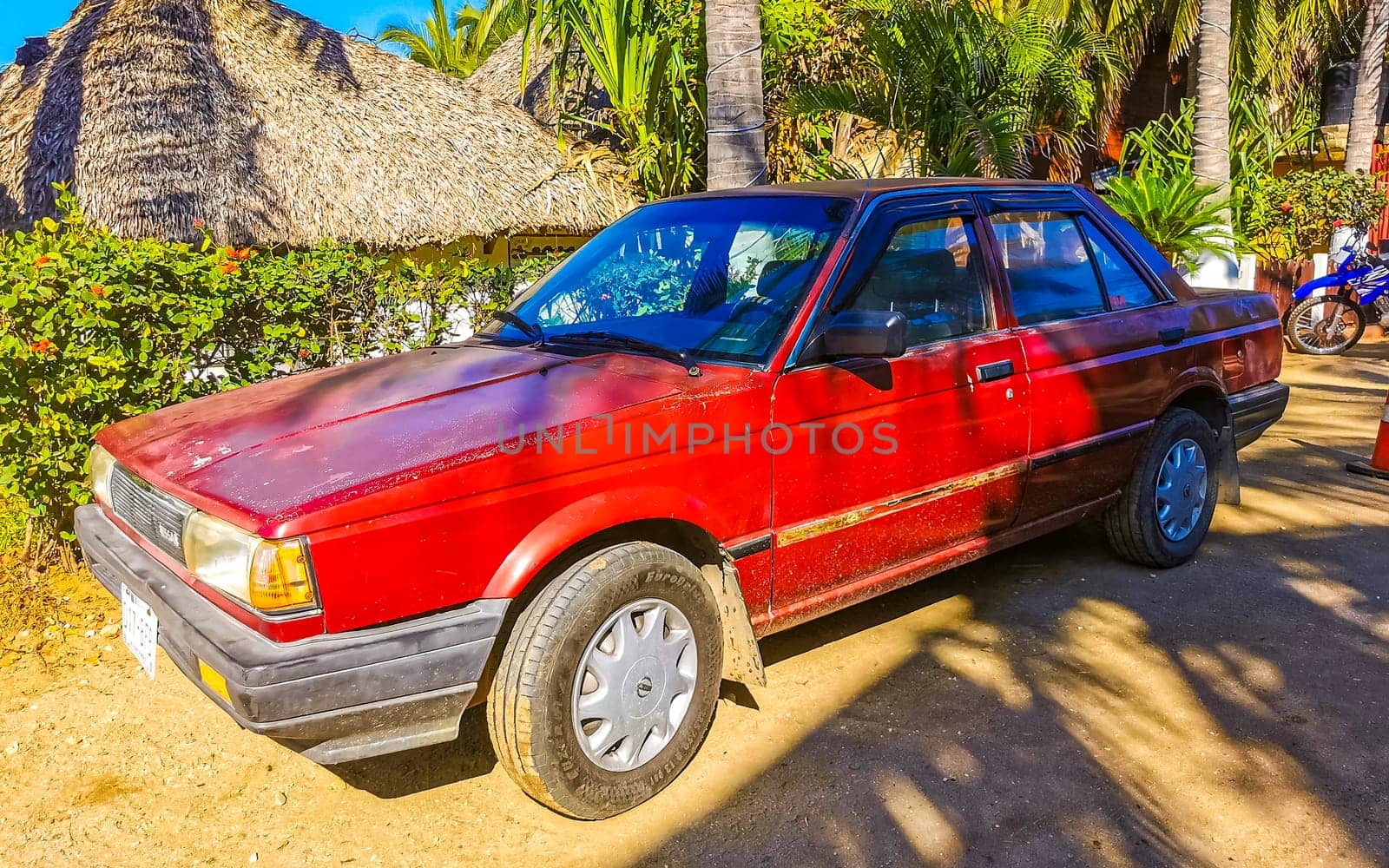 Red modern car vehicle transportation in the city town in Zicatela Puerto Escondido Oaxaca Mexico.